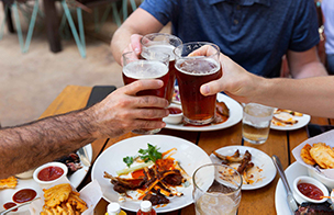 People making a toast with craft beer.