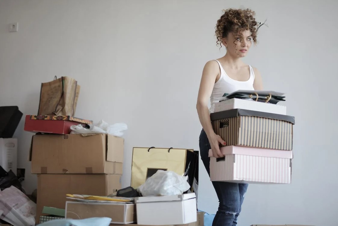 Woman decluttering as an example of one of the tips for showcasing your home's best features