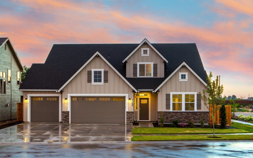 Large house with a garage during sunset