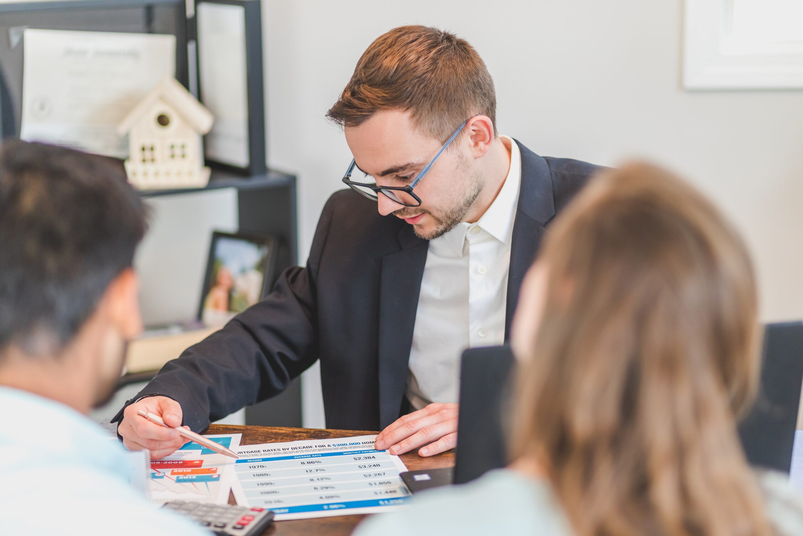 Financial advisor talking about mortgage refinancing with his clients