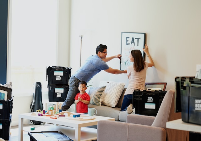 Couple and their young son unpacking after moving into a new home