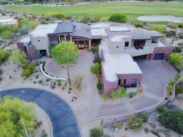 Bird's eye view of a luxurious property with a large golf course and driveway