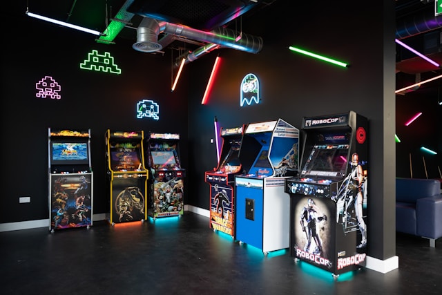 Arcade game machines in a dark room.