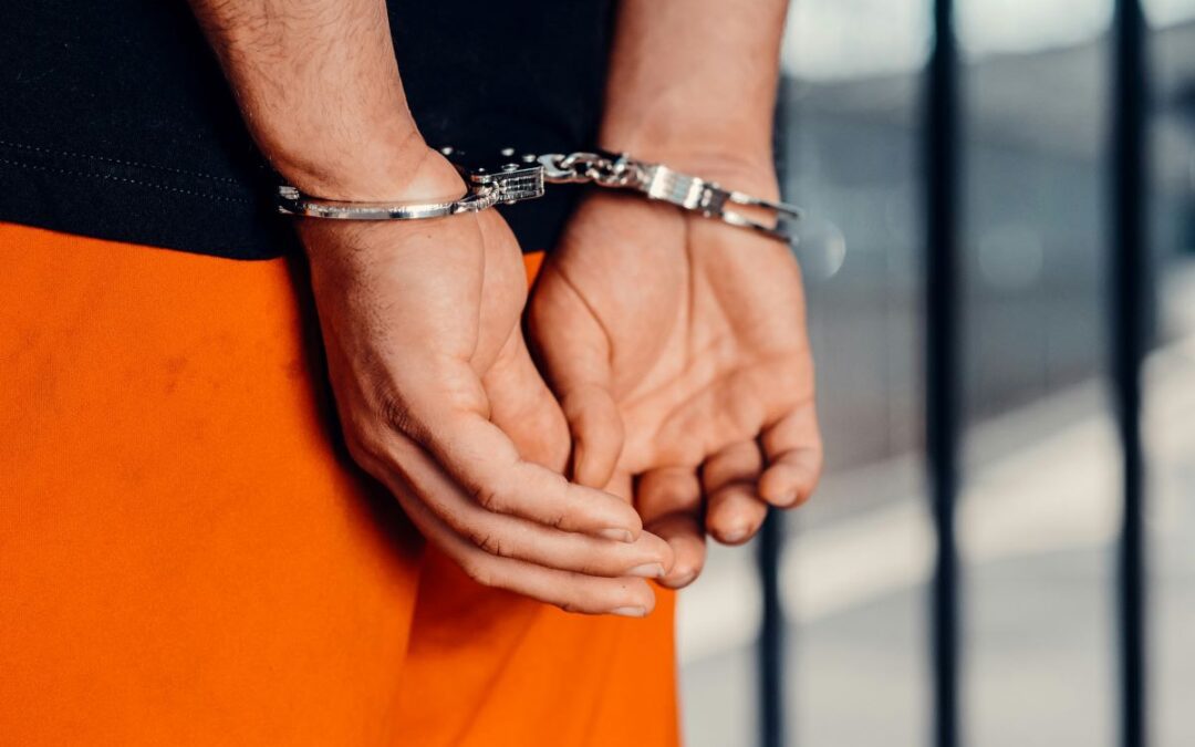 A man wearing handcuffs in prison